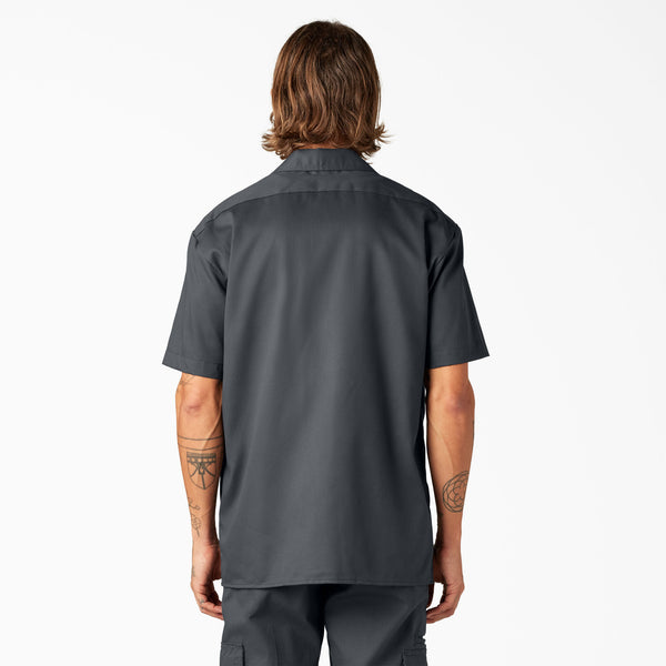 Man wearing a Dickies charcoal short-sleeve button-up shirt 
