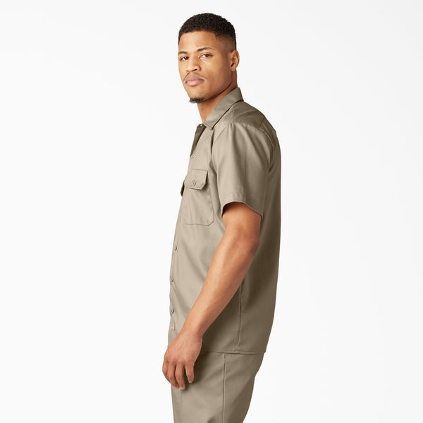 Man wearing a dickies dark sand short-sleeve shirt and dark sand dickies pants on a white background