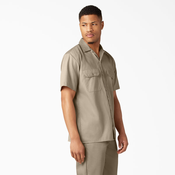 Man wearing a dickies dark sand short-sleeve shirt and dark sand dickies pants on a white background